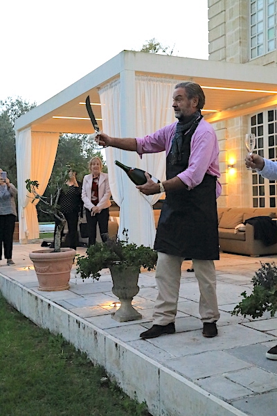 Ronald sabring the Champagne for the Farewell Dinner